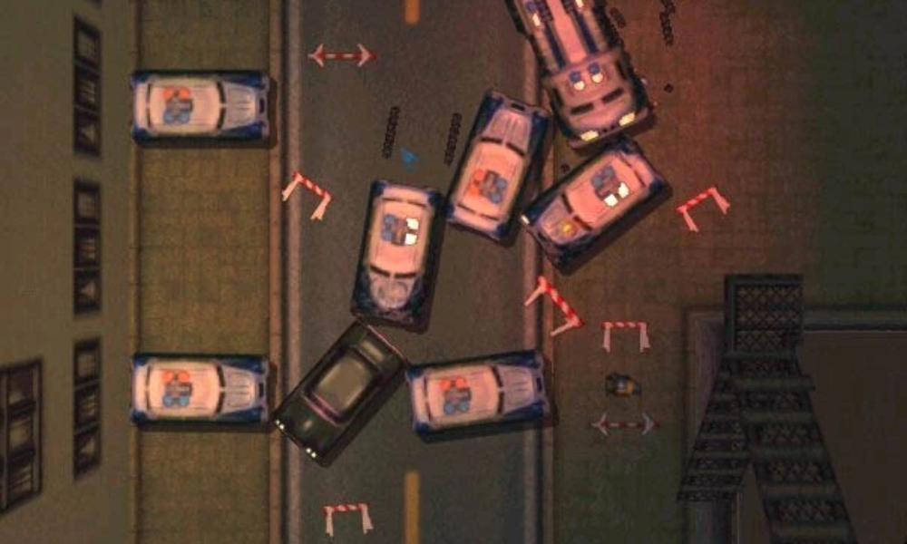 Several police cars blocking a dark street in the top-down view of Grand Theft Auto 2