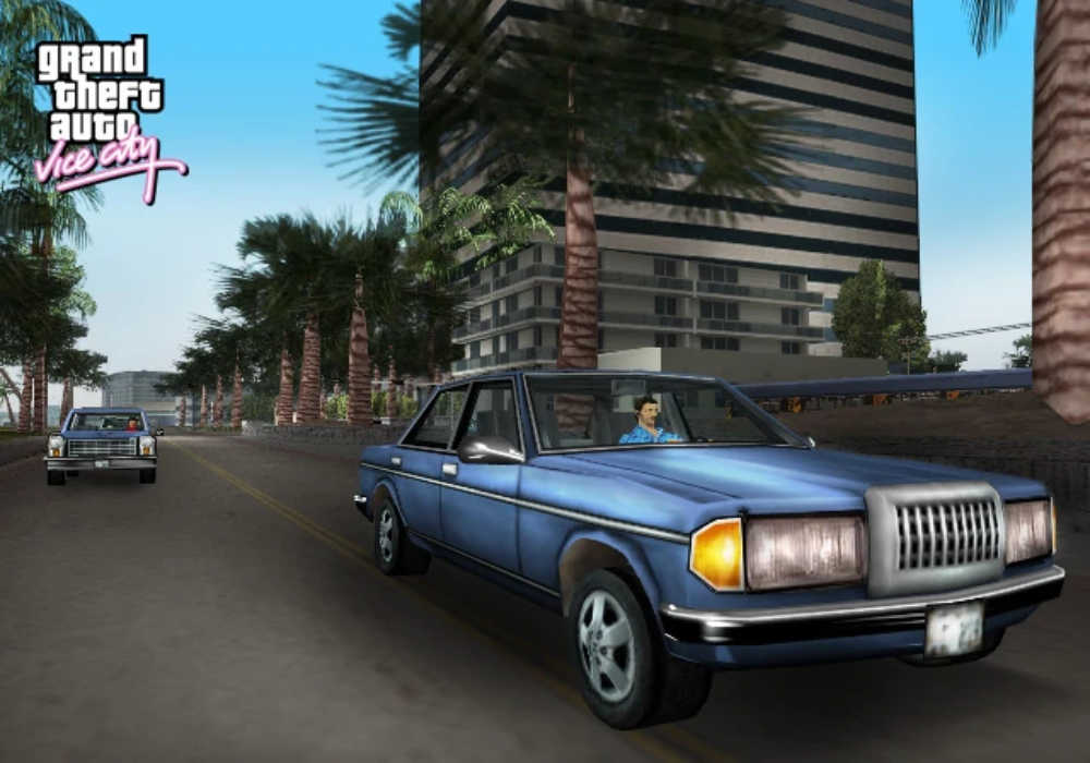 Blue sedan driving past palm trees and a high-rise building in GTA: Vice City