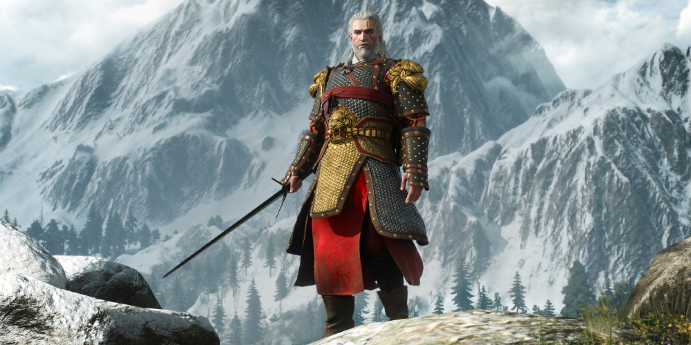 Geralt from Witcher 3 standing in front of a mountain in shiny gear.